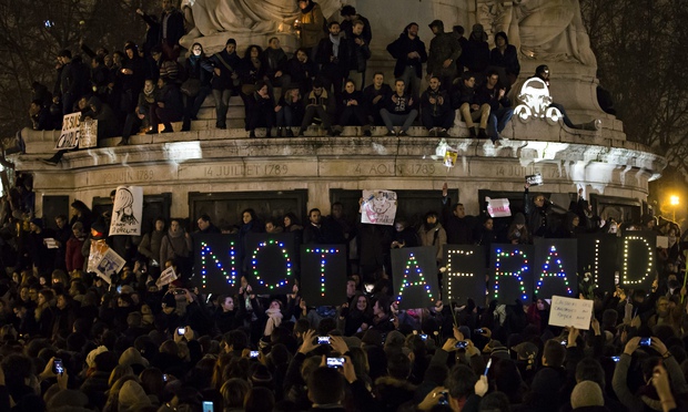 A sign reads 'not afraid' as thousands gather for a vigil on Place de la Republique in Paris on Wedn